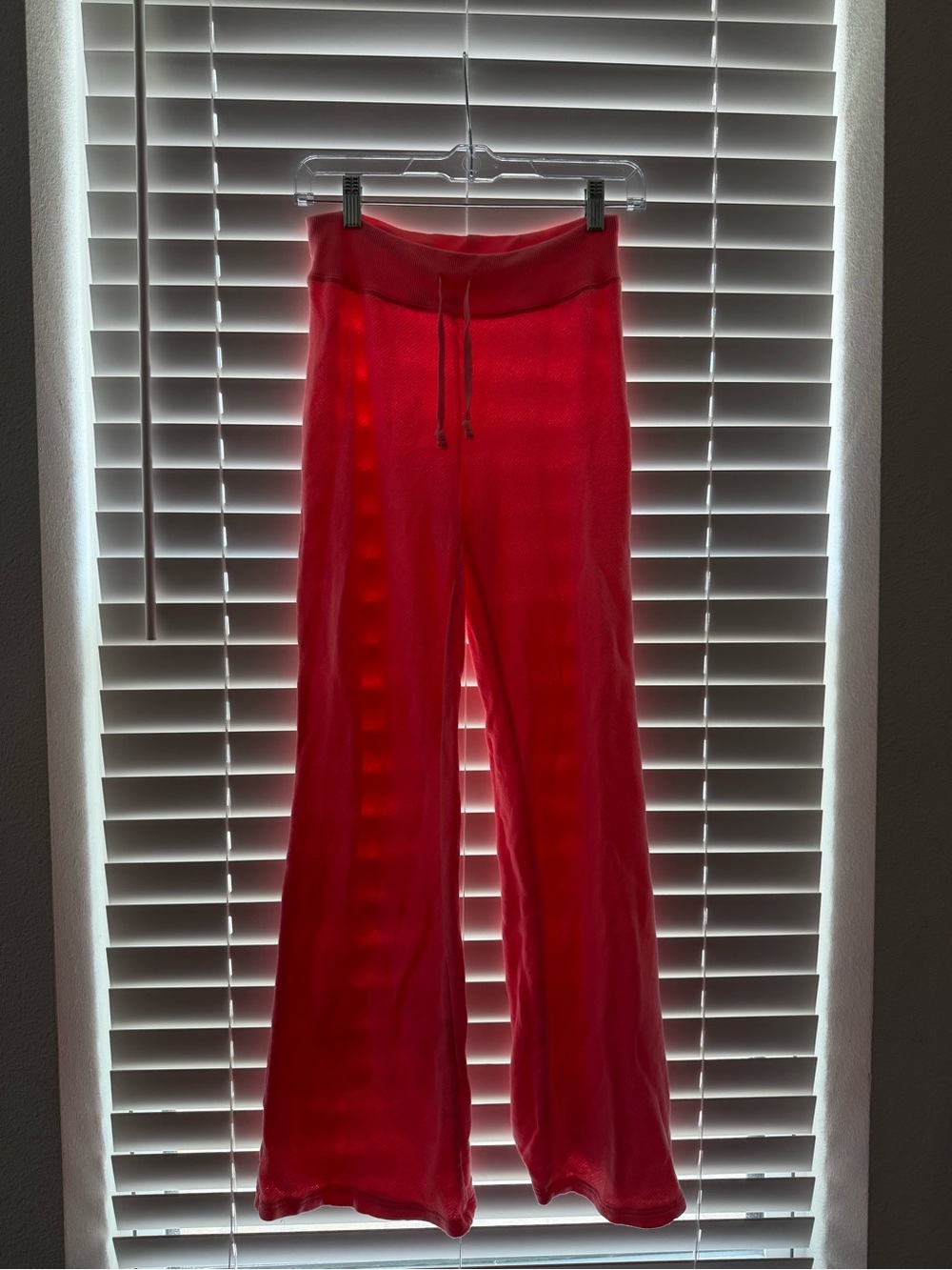 Bright pink Skims sweatpants